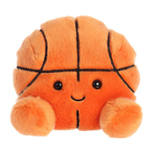 Hoops is a vibrant orange plush with black lines crisscrossing to mimic a basketballs segments, and her cheerful face!