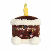 B'day Cake plush from Palm Pals, resembling a chocolate birthday cake with colorful sprinkles and a yellow candle
