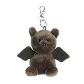 Plush keychain of a gray bat by Palm Pals with black wings, small ears, and round embroidered eyes.