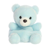 A small powder-blue bear plush with a white snout and gentle smile from Palm Pals by Aurora