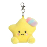 A small yellow star plush clip-on with rosy cheeks and a pastel rainbow accent from Palm Pals