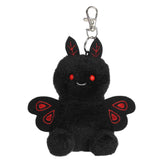 A small black mothman plush clip-on with red eyes and embroidered crimson wings from Palm Pals