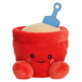 June Sand Bucket plush, red bucket with blue shovel, sand accent, and smiling face, from Palm Pals.