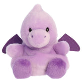 A pterodactyl plush toy from Aurora with purple fur, little wings, and a sweet embroidered face.