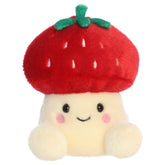 A mushroom plush toy from Aurora with a cream body, smiling embroidered face, and a strawberry cap with leafy green details.