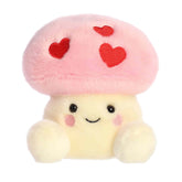 A pink mushroom plush with red heart spots and a sweet smile from the Palm Pals Valentine’s Collection