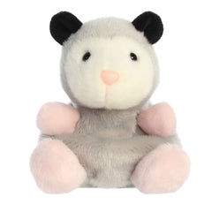 Plush toy of a gray and white opossum in the Palm Pals collection with black ears and pink paws.