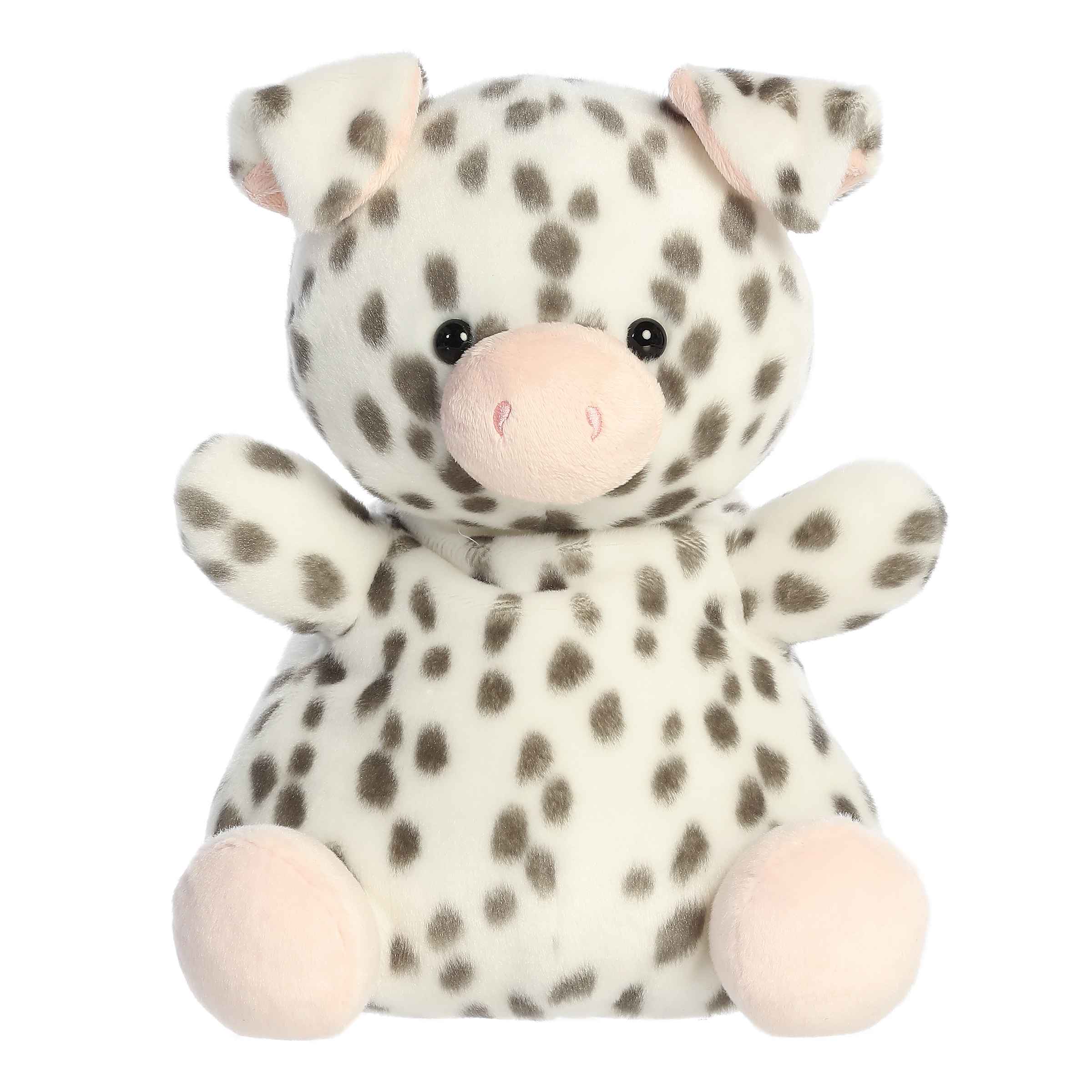 Larger plush toy of a white piglet in the Palm Pals collection, covered in black spots