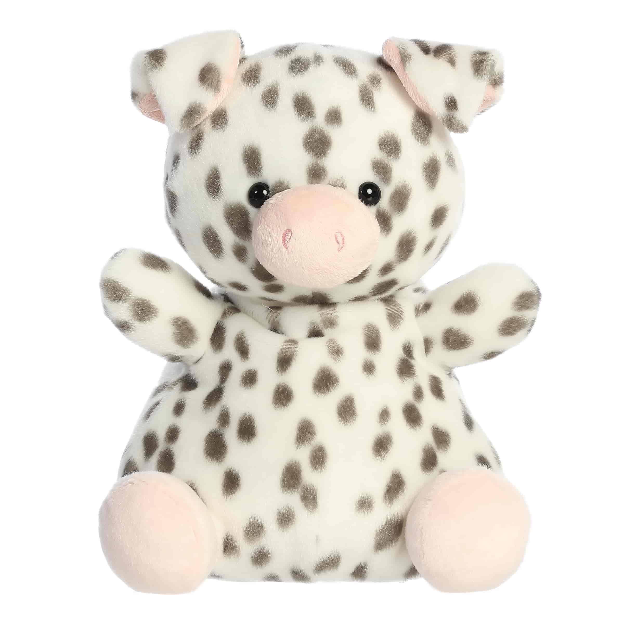 Larger plush toy of a white piglet in the Palm Pals collection, covered in black spots