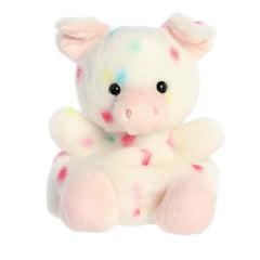 Plush toy of a white pig by Palm Pals with pastel confetti dots, a pink snout, and matching hooves