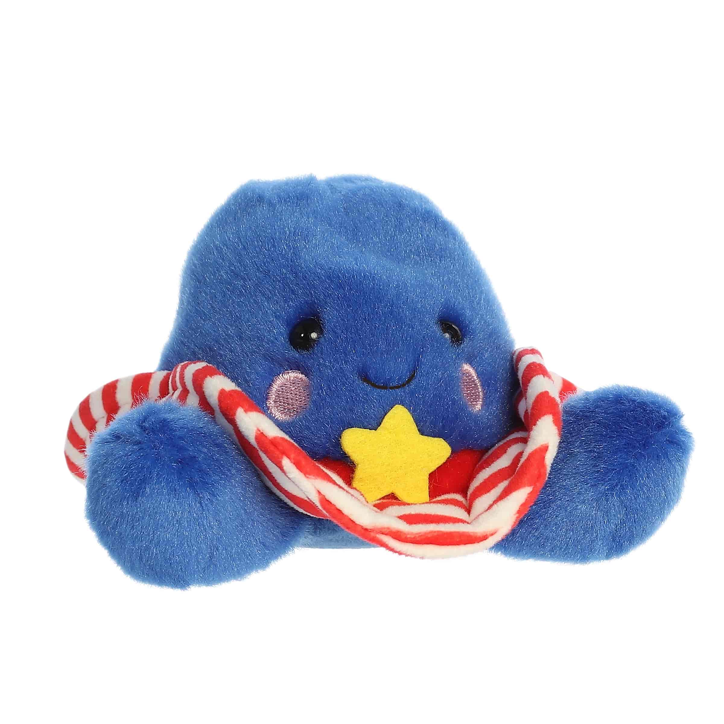 A small red, white, and blue cowboy hat plush with a gold star badge from Palm Pals by Aurora.