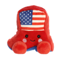 A small red cowboy boot plush with blue accents and a star-spangled flag design from Palm Pals by Aurora.