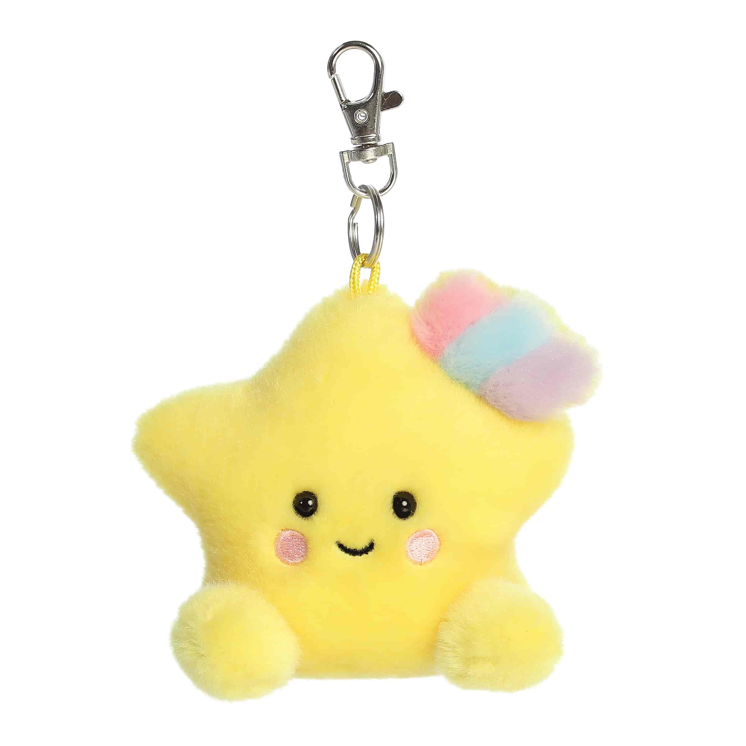 A small yellow star plush clip-on with rosy cheeks and a pastel rainbow accent from Palm Pals