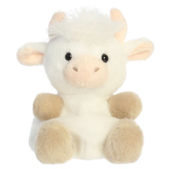 A highland cow plush toy from Aurora with fluffy white fur, tiny horns, soft hooves, and an embroidered face.