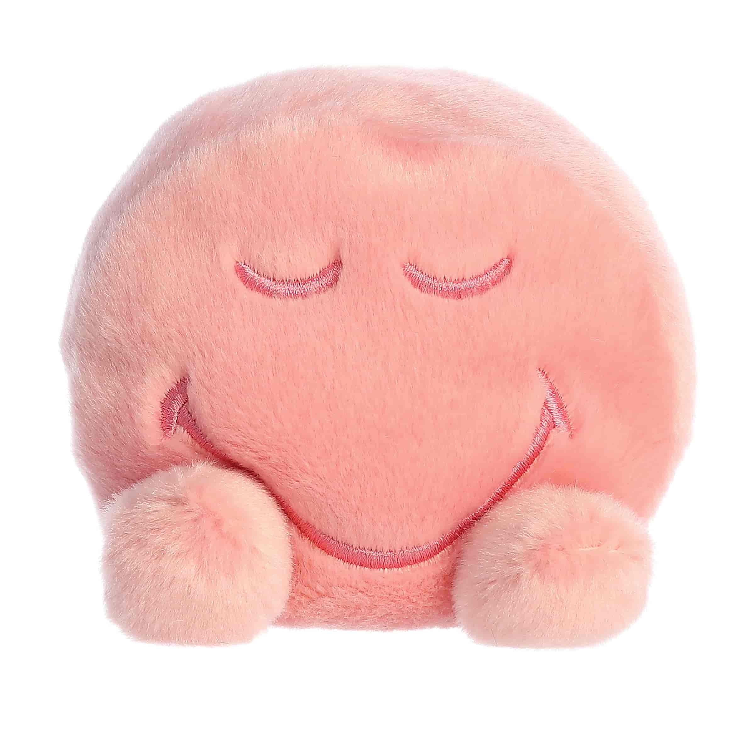 A soft pink plush with closed eyes and a peaceful smile from the SmileyWorld Palm Pals Collection