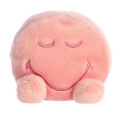 A soft pink plush with closed eyes and a peaceful smile from the SmileyWorld Palm Pals Collection