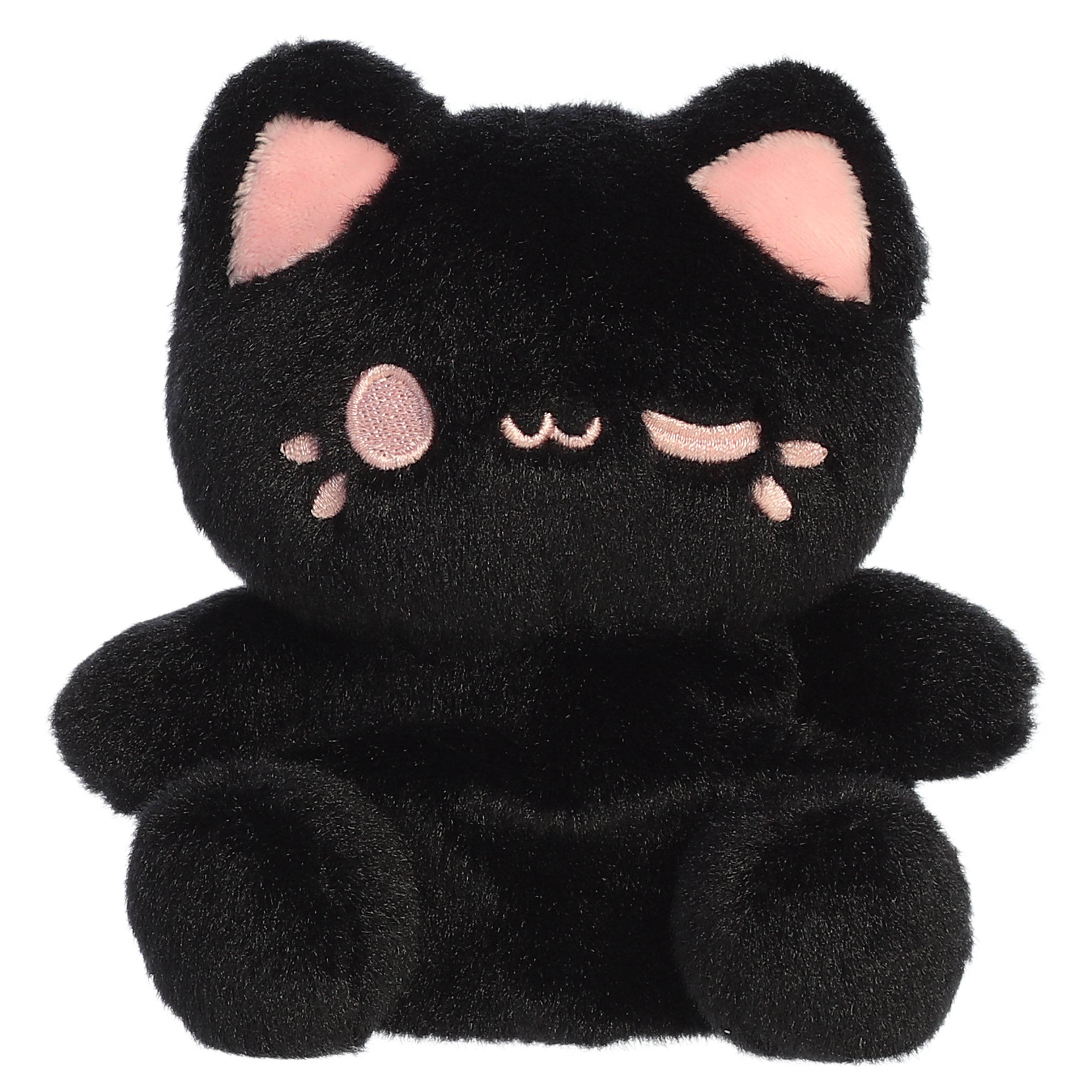 A black cat plush toy from Aurora with rounded paws, pink inner ears, and a strawberry pink facial expression.