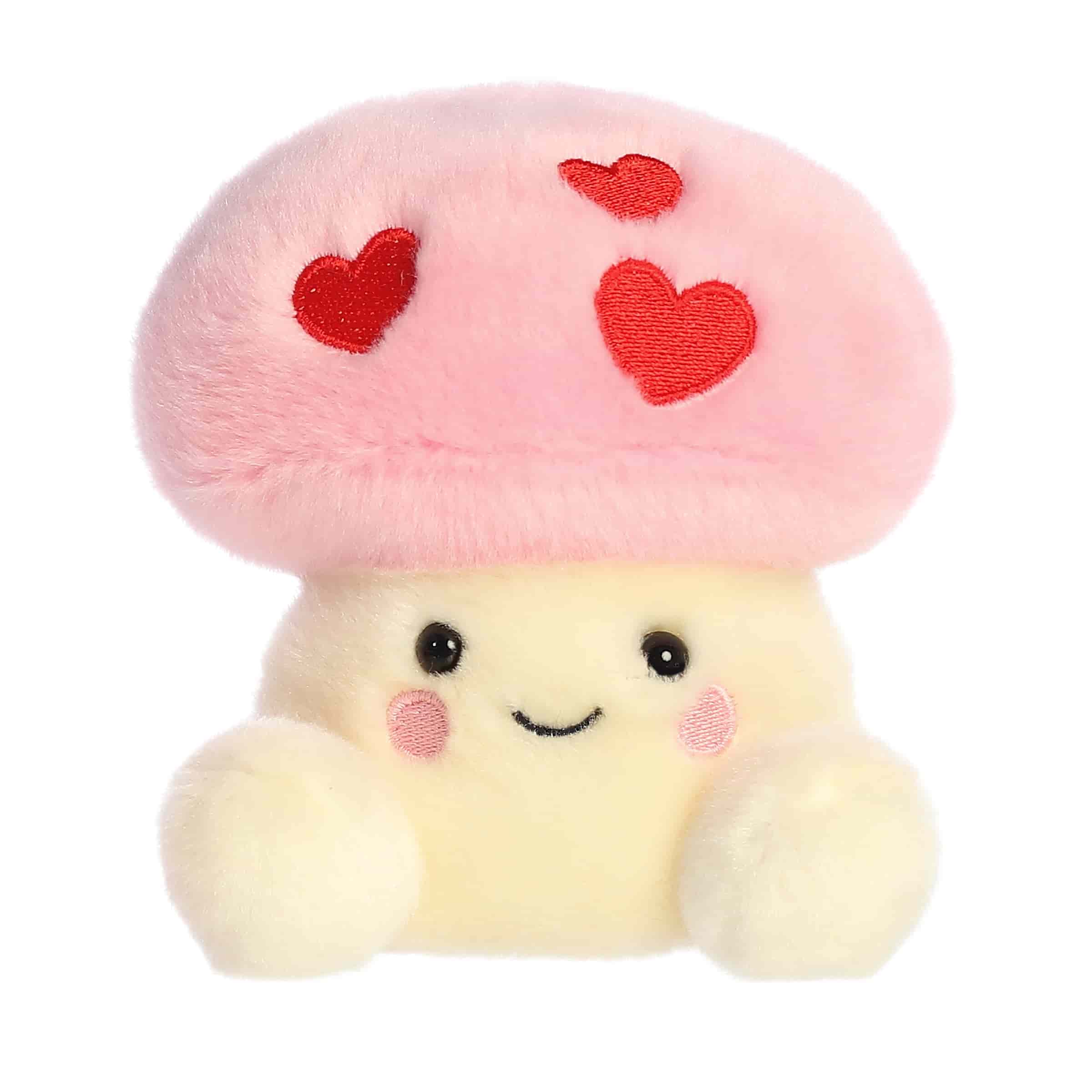A pink mushroom plush with red heart spots and a sweet smile from the Palm Pals Valentine’s Collection