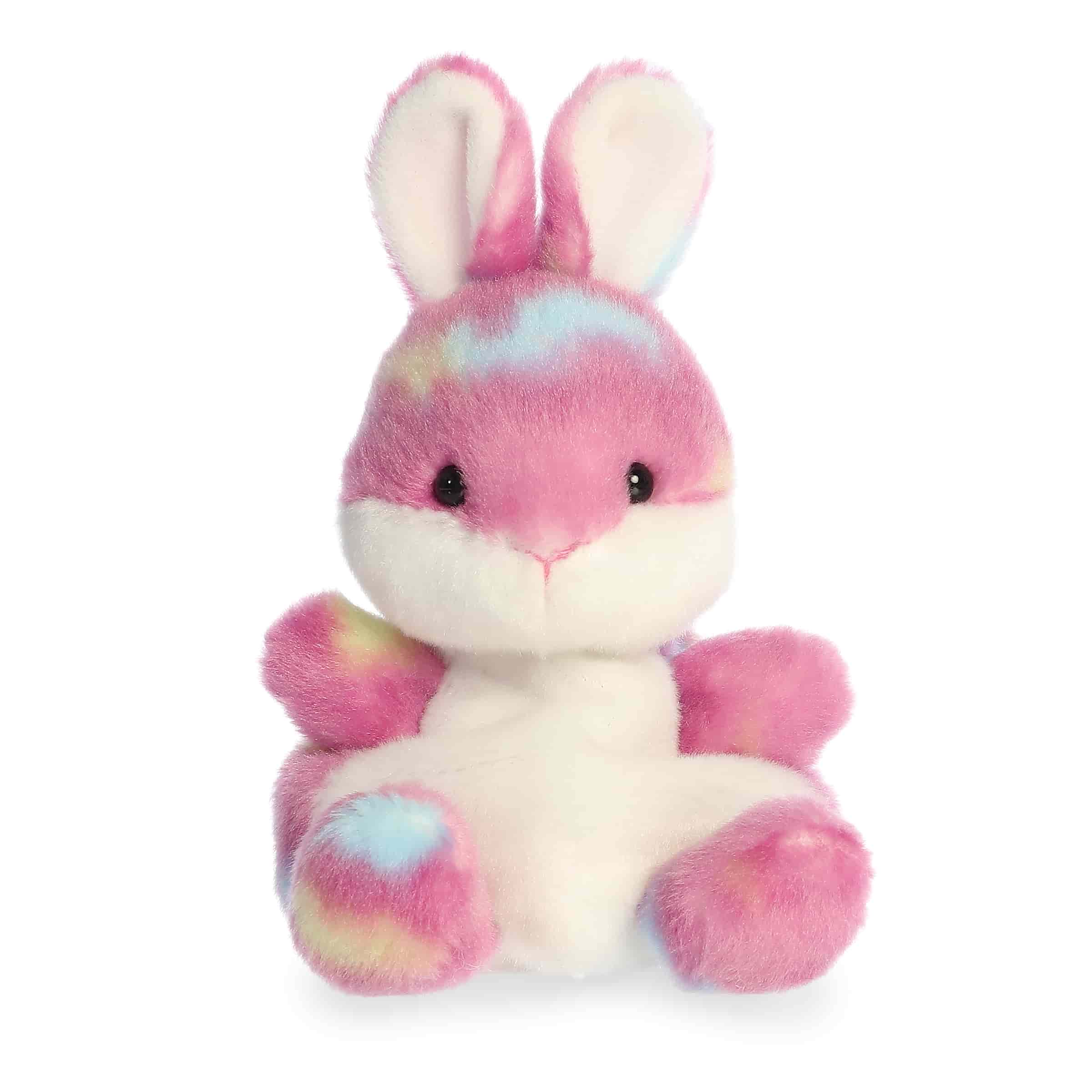 Pink bunny plush with candy-style accents, rounded Palm Pal shape, soft fabric body, and cheerful face