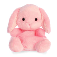 Pink lop bunny plush with floppy ears, rounded Palm Pal shape, soft fabric body, and gentle face