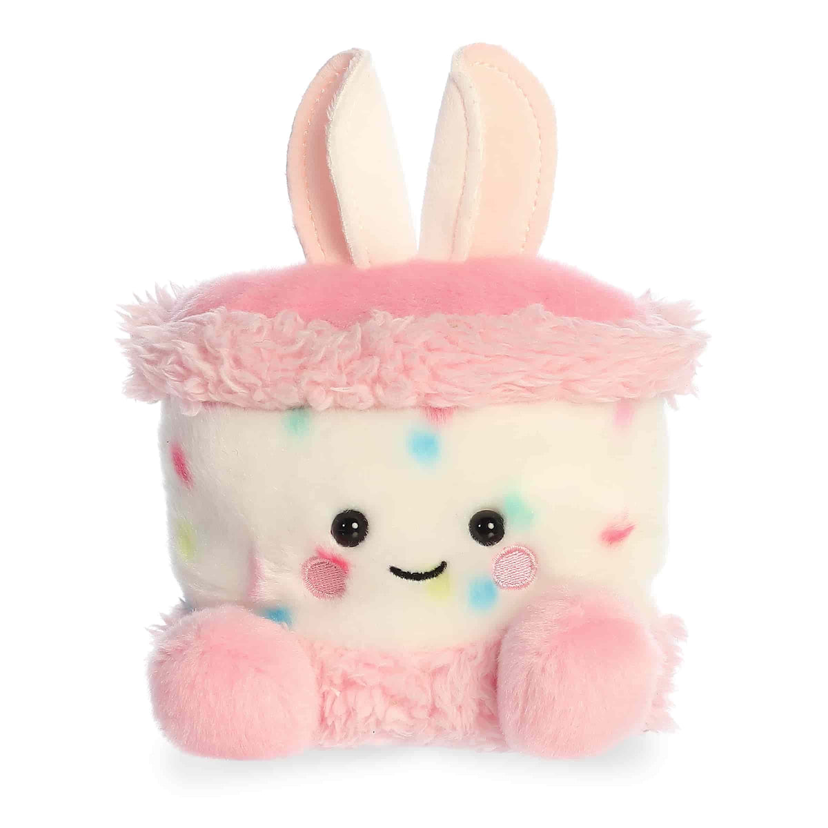 Bunny cake plush with pastel frosting colors, rounded Palm Pal shape, soft fabric body, and smiling face