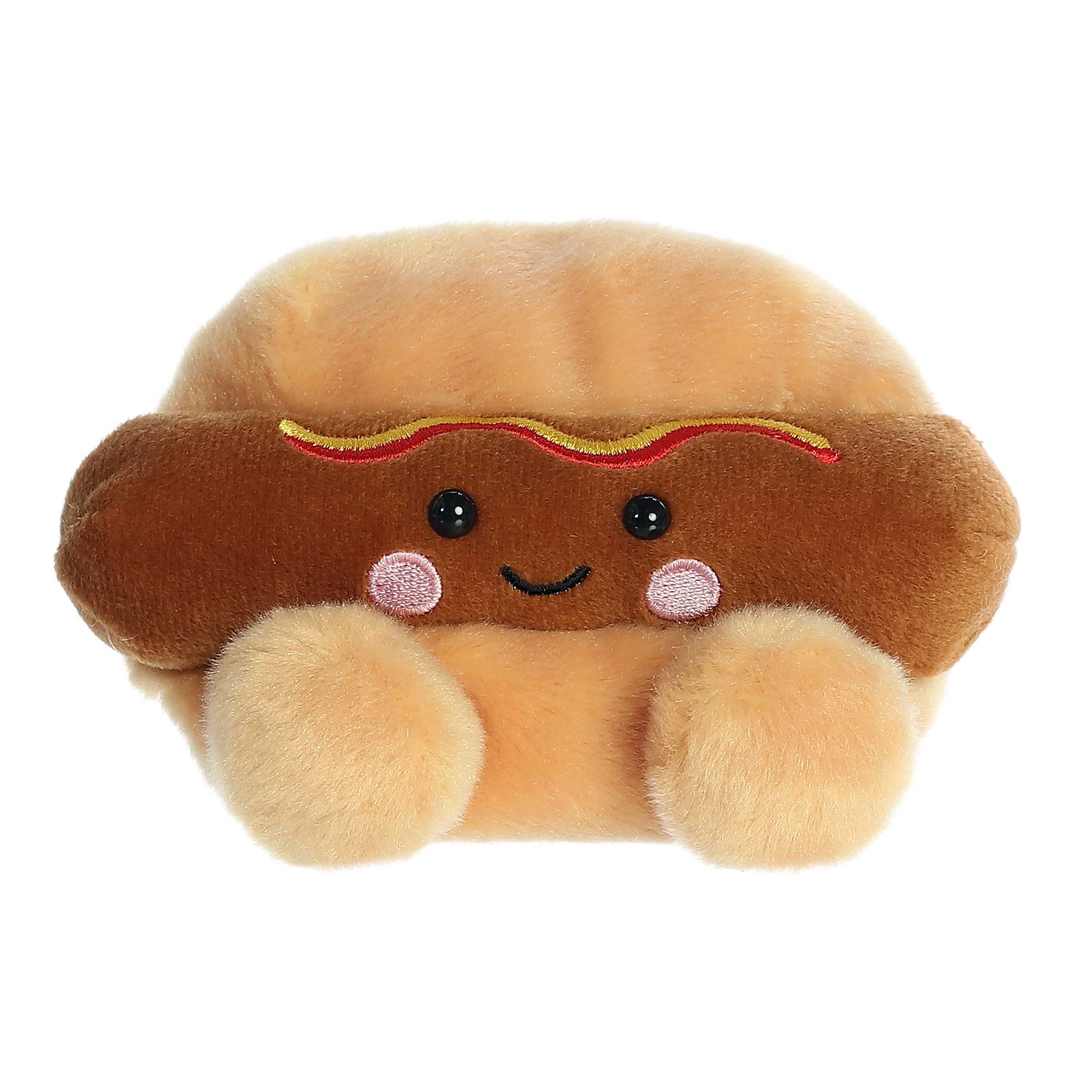 An adorable hot dog plush with a tan bun and round feet and a dark brown hot dog that blushes and smiles