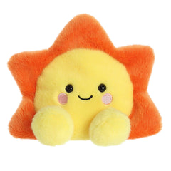 Rae Sun from Palm Pals, a bright yellow plush with a comforting glow, perfect for carrying a piece of the sky